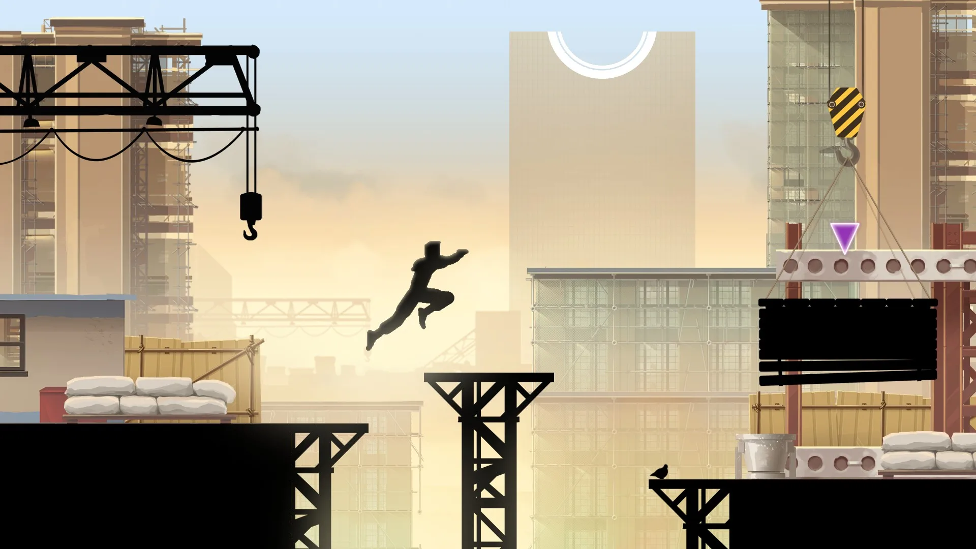 A runner jumps between cranes on a construction site at dawn